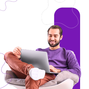 A digital marketer reviewing SEO analytics on a laptop, with keyword data, rankings, and website performance charts visible.